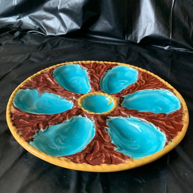 This stunning 19th-century S. Fielding & Co. Majolica Oyster Plate features six vibrant turquoise-blue oyster wells...