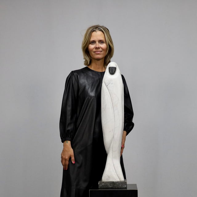 Paul Simons Eastern Woman, 1980s Marble and stone base Height 81 cm Vertical composition in white marble with dark stone...