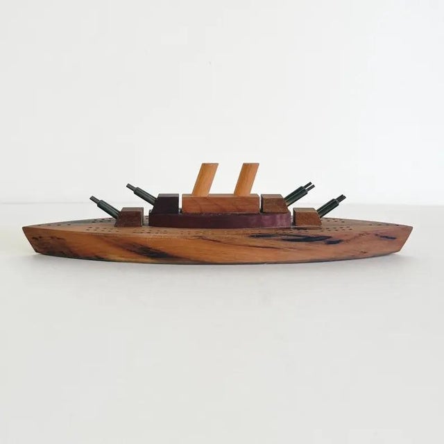Cribbage board made in Oregon in the 1970s from richly grained myrtlewood. Carved in the form of a battleship, the board...