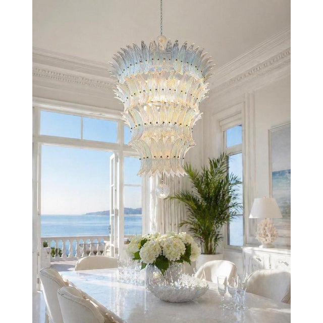 It is not a chandelier. It is an apparition. Composed of 152 Murano glass elements, each piece shaped by hand like a...