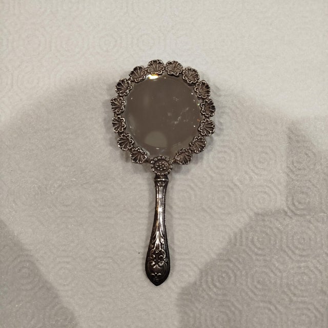 Silver Hand Mirror. 57 grams. Height: 5.91 in (15 cm) Width: 2.76 in (7 cm) Depth: 0.4 in (1 cm) This piece has an...