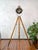 Antique copper francis searchlight 1930s on an old wooden surveying tripod | marine ship lamp spotlight: the lamp is...