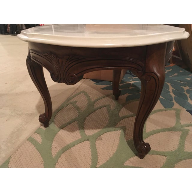 Beautiful table made of select fruitwood having three carved cabriole legs and topped with removable Italian marble curved...