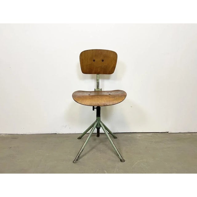 This industrial height adjustable, rotating chair was made in former Czechoslovakia during the 1950s.It features an iron...