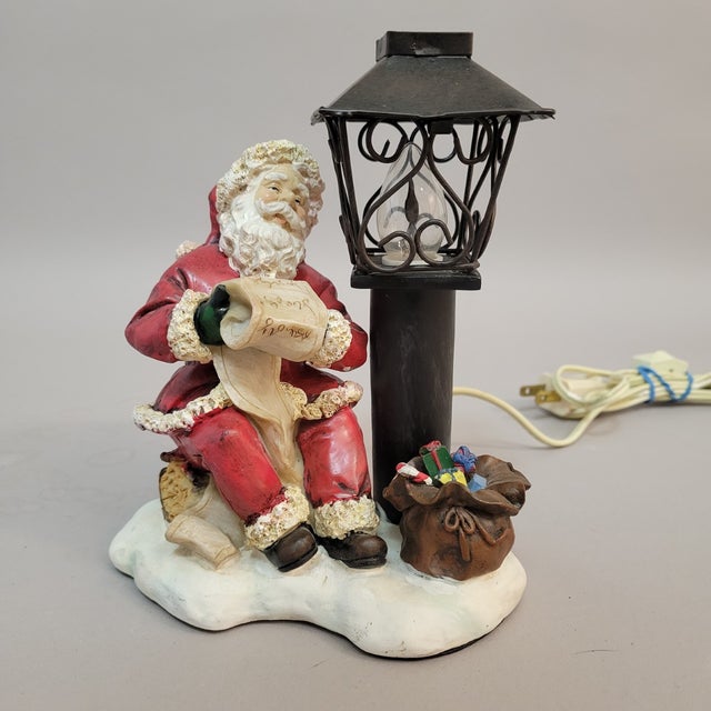 A charming vintage Santa Claus figural accent lamp dating to the late 20th century. The hand-painted ceramic Santa is...