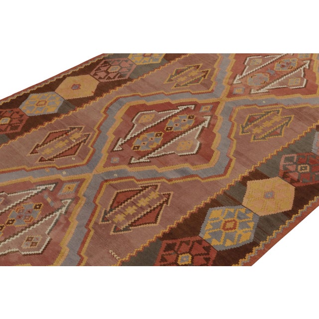 Originating from Turkey circa 1950-1960, a 7x14 mid-century kilim rug featuring an unusual marriage of colorway and...