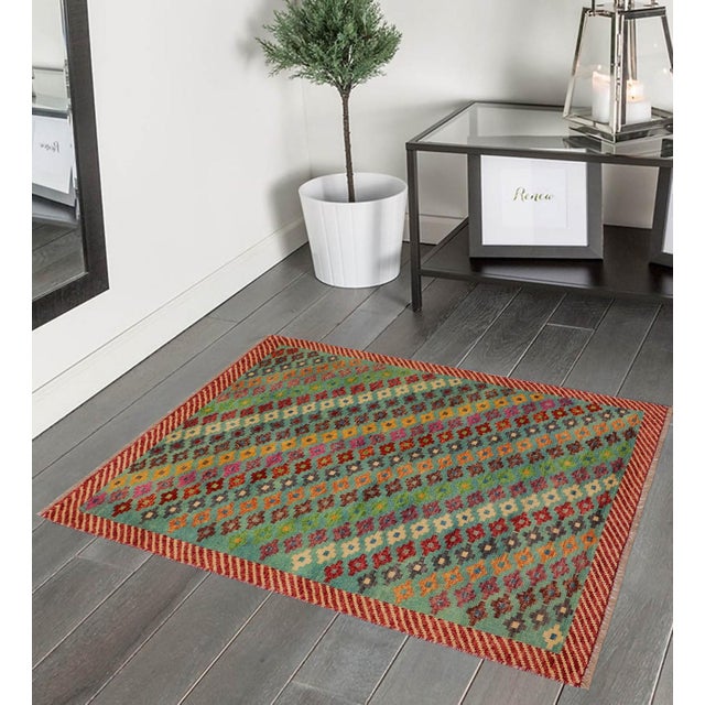 This stunning hand-knotted Afghan Balouchi rug is a captivating addition to any decor. Crafted by skilled artisans, it...