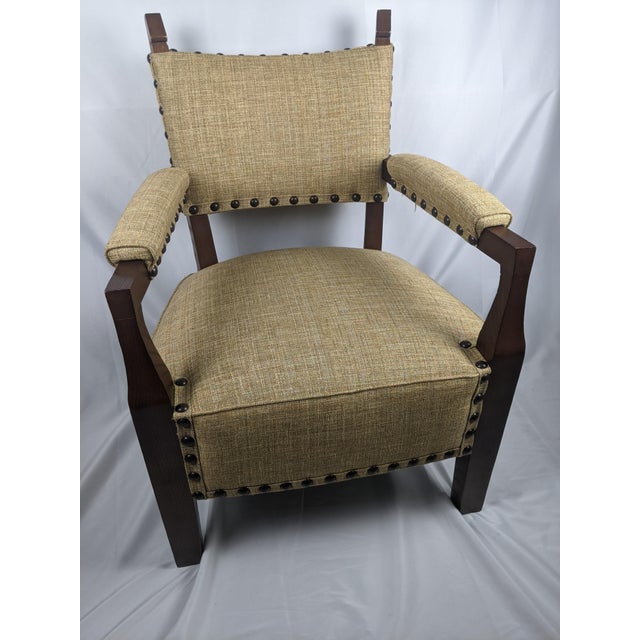 A striking and exceptionally well-preserved mid-century armchair inspired by classic Mission and Arts & Crafts design....