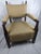 A striking and exceptionally well-preserved mid-century armchair inspired by classic Mission and Arts & Crafts design....