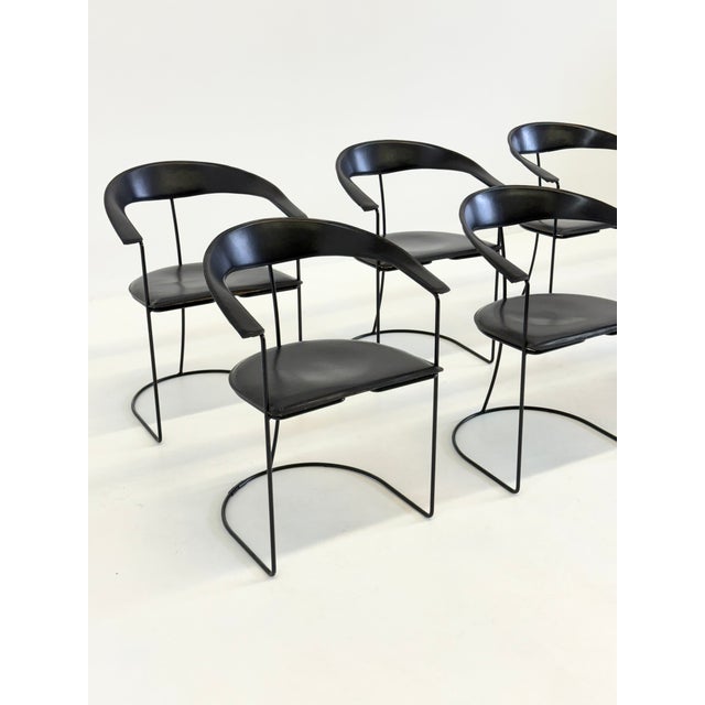 Beautiful set of 8 vintage Arrben Ursala chairs , upholstered in black leather with a black frame . The chairs feature a...