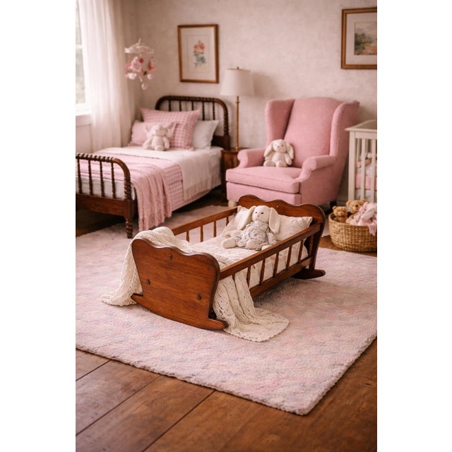 A charming antique wooden doll cradle, beautifully refinished and styled for modern interiors. With its sculptural...