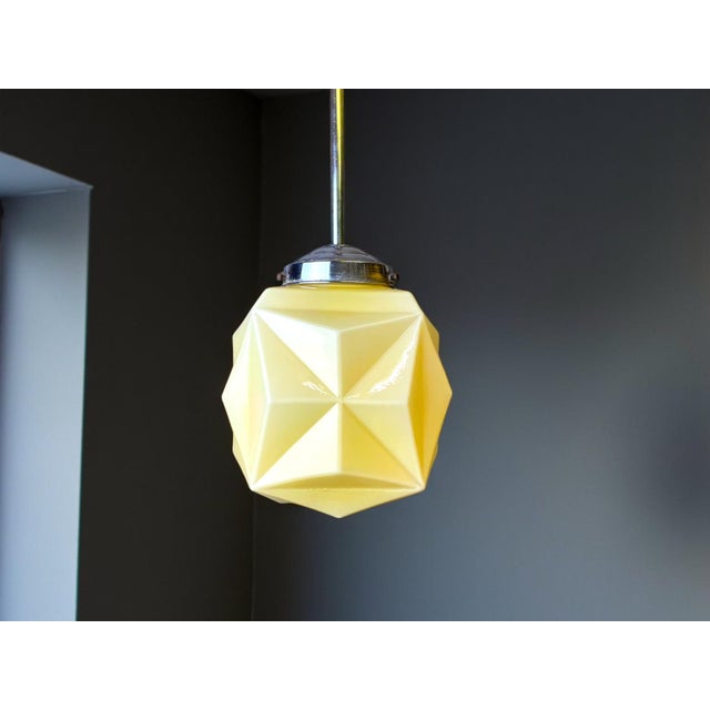 Art Deco Light Fixture This is a beautiful light fixture made in the 1960s in the style of Art Deco. The globe is made in...