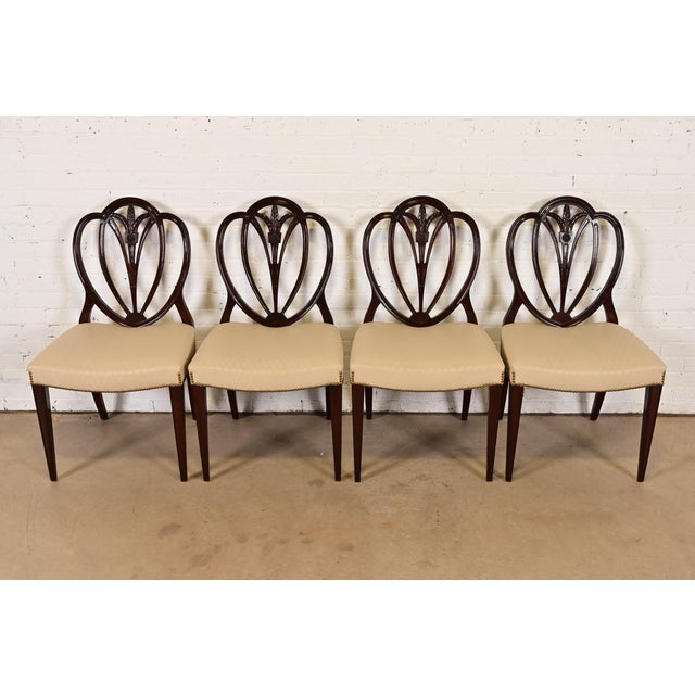 A gorgeous set of four Georgian or Regency style shield back side chairs or dining chairs In the manner of Baker Furniture...