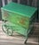 This antique Paalman Furniture green drophandle tea wagon with an Asian scene painted on the drop leafs made in Grand...