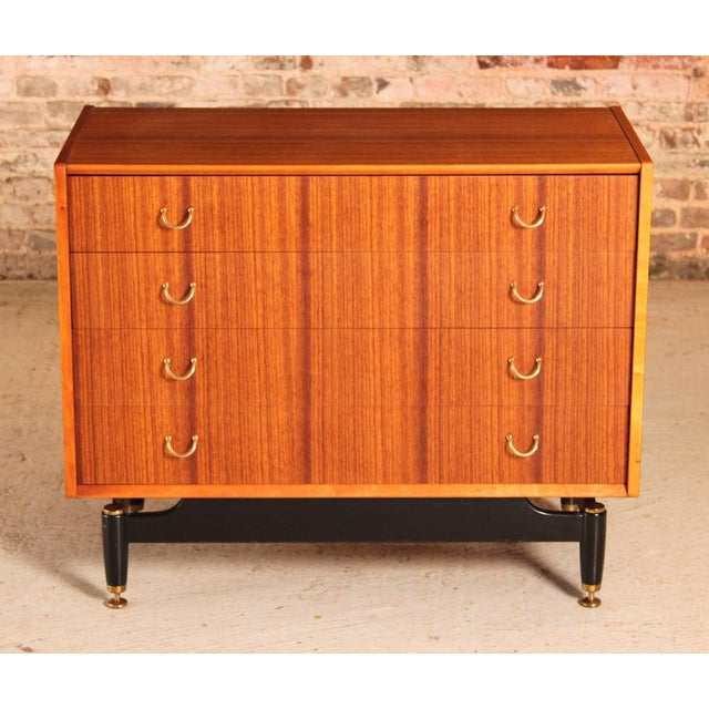 Mid Century G-plan Librenza tola and black chest of drawers with brass handles, circa 1960s. Two top drawers have 3...