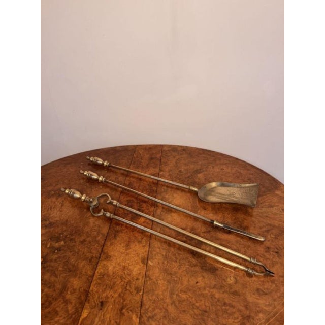 Fine quality antique Edwardian brass fire irons and fire dogs, having a quality set of three brass fire irons comprising...