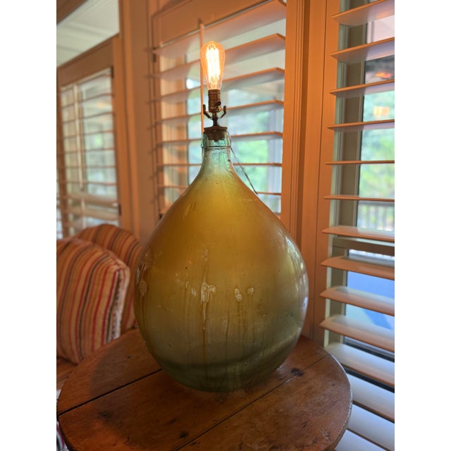 Make a statement with this striking vintage table lamp crafted from an oversized hand-blown glass demijohn (carboy)....