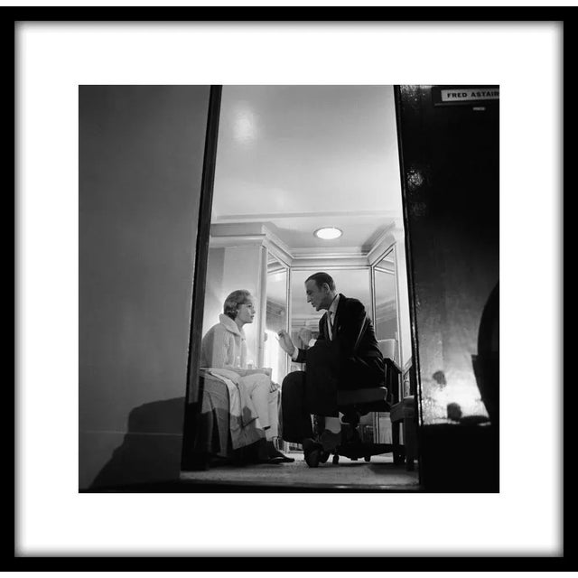 Debbie Reynolds talking with Fred Astaire in his dressing room during a break in filming "The Pleasure of His Company,"...