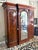 This impressive 19th Century Triple Wardrobe showcases richly figured flamed mahogany, arched panel doors, carved...