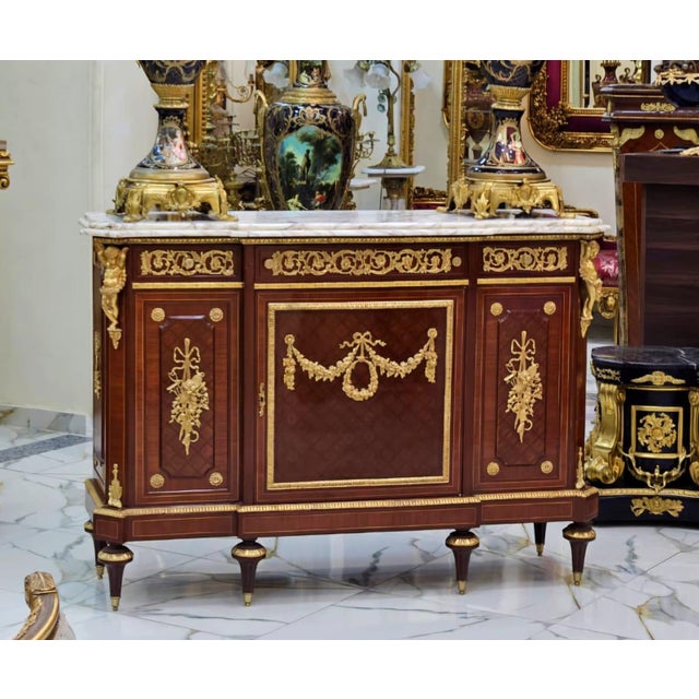 Elevate your home with this magnificent French Louis XVI-inspired sideboard, masterfully crafted from fine wood and...