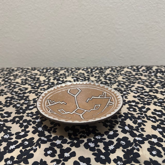 Infuse your space with the warm, rustic charm of the desert with this Southwestern-style hand-painted pottery plate. This...