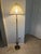 This antique-style brass floor lamp features onyx accents on the central column and a decorative cast metal base with...