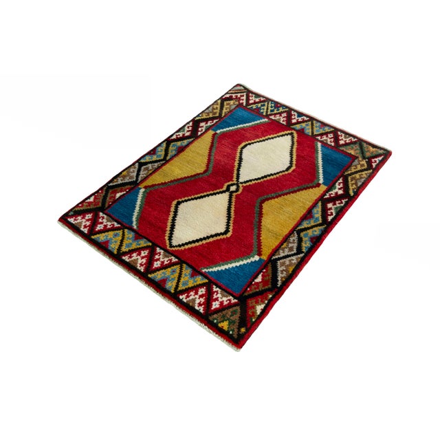 A colorful unique piece of traditional nomad art! This hand-knotted Gabbeh rug impresses with its geometric patterns,...