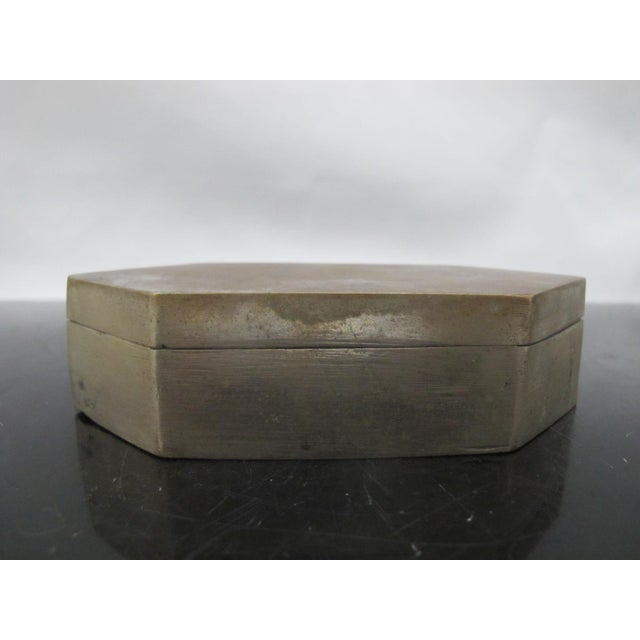 Most likely Indian, possibly Chinese, antique brass box with hinged lid. Hexagonal shape, showing 6 sides. Hinged lid...