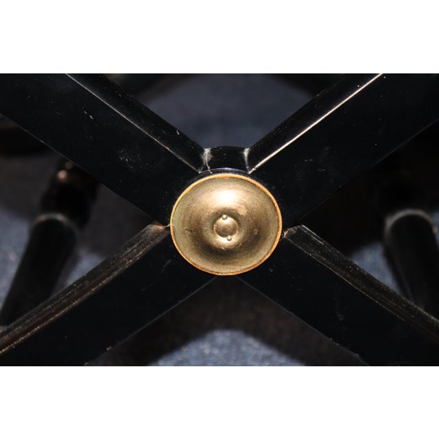 A wonderfully chic and unusual French Louis XVI-style ebonized X-frame bench, combining classical neoclassical form with...