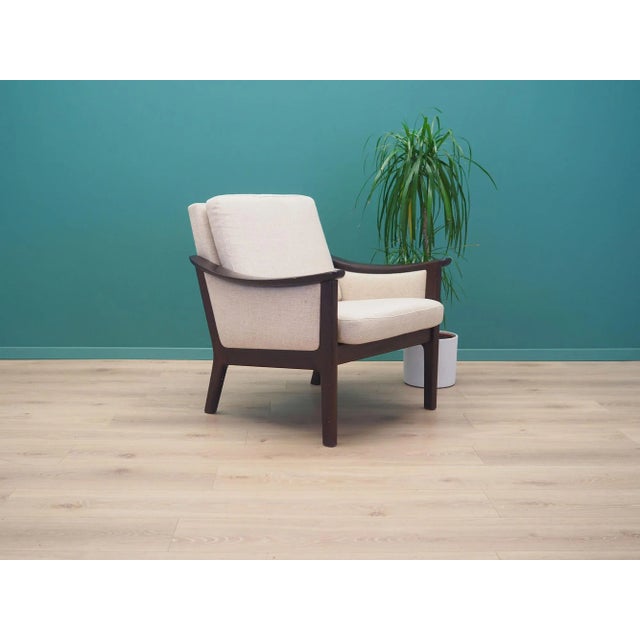 The armchair was made in the 1970s, Danish production. The structure was made of mahogany wood. The wood has been...
