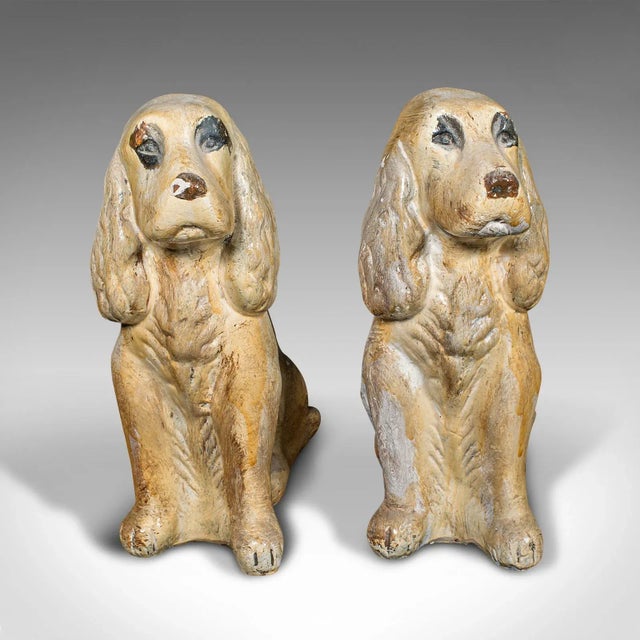 This is a pair of antique cocker spaniel figures. An English, plaster dog fireside ornament or doorstop, dating to the...