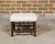 An English bobbin leg stool from the 19th century with new linen upholstery secured with a brass nailhead trim. This...