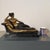 Elegant bronze sculpture depicting a reclining female figure on an ornate chaise lounge, in a style inspired by 19th-...