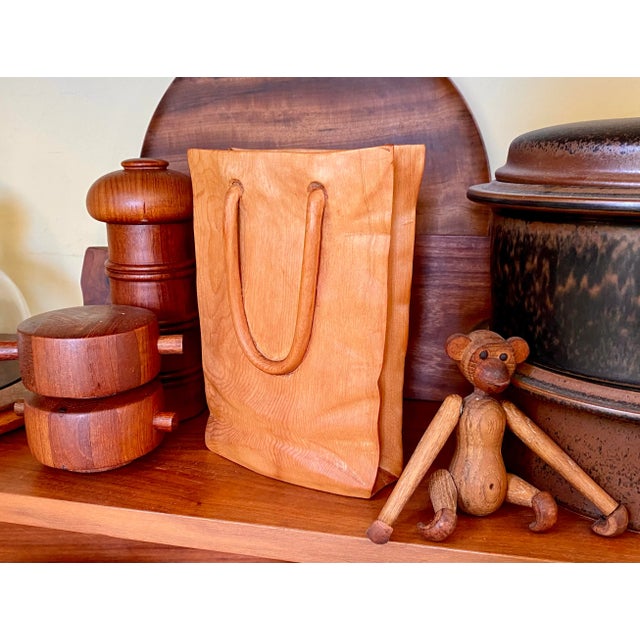 A signed and numbered hand carved wooden Shopping Bag sculpture by Venitian artist Livio De Marchi. Approx. dims: 7-1/2:H...