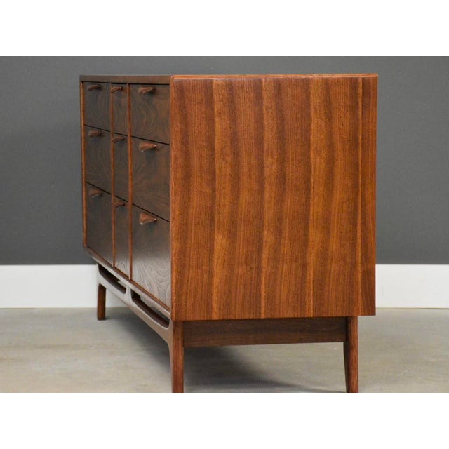 A mid century modern walnut nine drawer dresser with sculpted pulls made by Lane Perception. Professionally refinished....