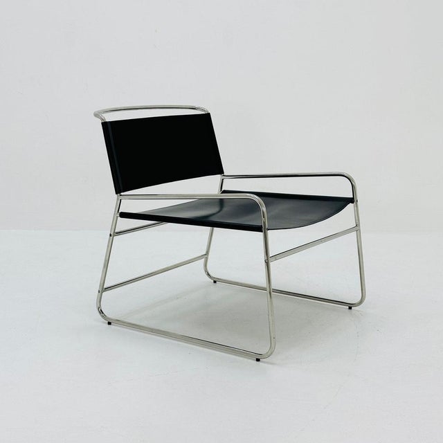 Mid century black leather lounge chair in Bauhaus style . Stylish lounge chair made of stainless steel with a leather seat...