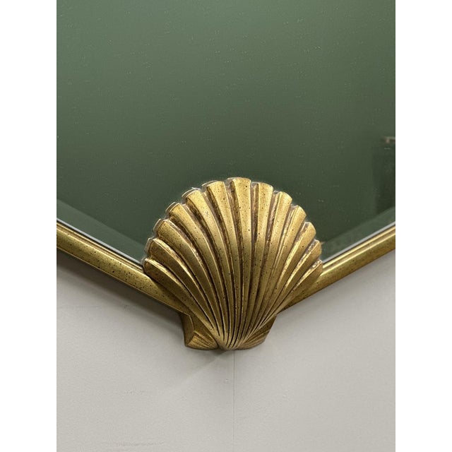 a sculptural 1980s deknudt mirror featuring an elegant fan-shaped silhouette in deep green glass, beautifully framed with...
