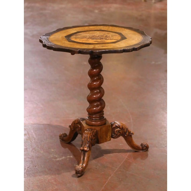 An intricate Alpine village scene and a richly carved pedestal make this antique Black Forest tilt-top table a distinctive...