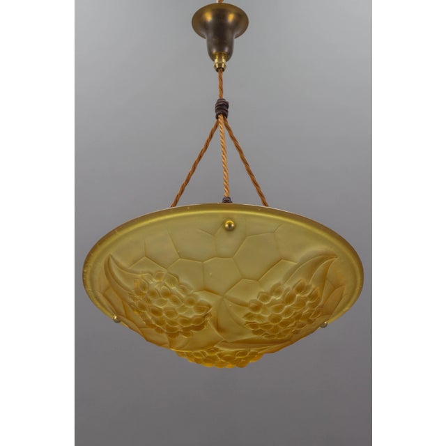 Beautiful French Art Deco period frosted molded glass shade in amber color with a floral and geometric design, signed ROS,...