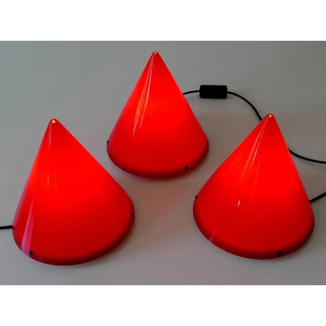 Set of three lovely Modernist table lamps or sconces 'Cone' in red acrylic. Designed by Verner Panton in 1995....