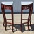This is a beautifully carved pair of red mahogany corner tables or pedestals with white stone tops. Unmarked but likely...