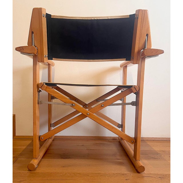The folding director's chair, produced by Fratelli Reguitti and designed by Carlo Hauner in 1973. Made of solid wood with...