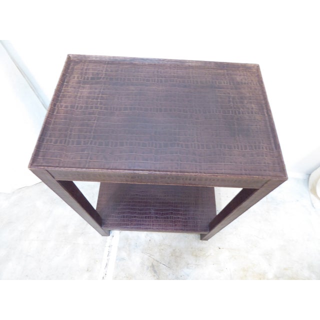 This leather covered console table has an embossed alligator design.