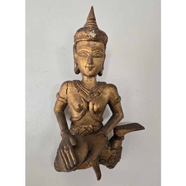 Thai or Burmese hand-carved wooden figures, representing celestial musicians, the sculptures feature a gold gilt finish,...