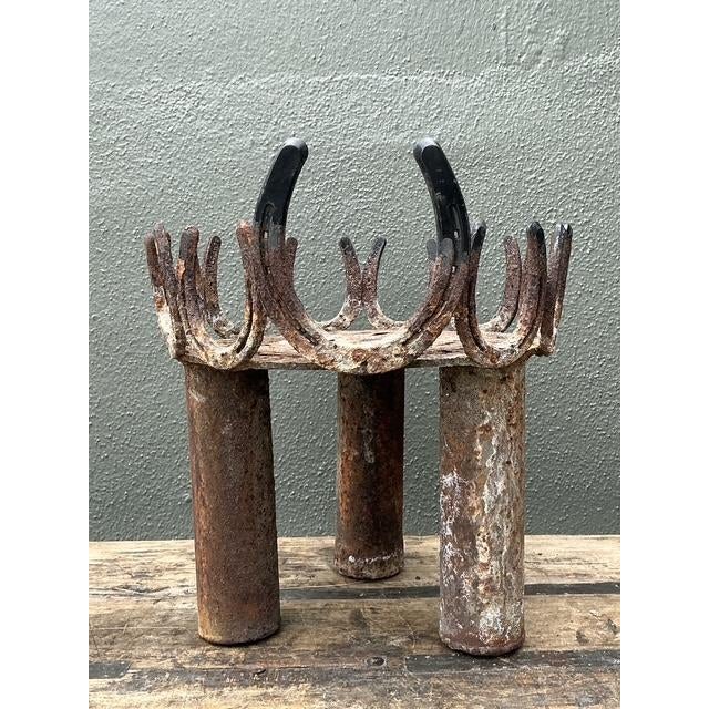 This striking vintage plant stand is a masterclass in American folk art and industrial repurposing. Expertly hand-welded...