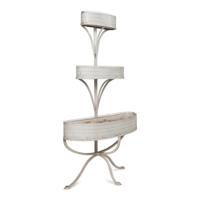 A charming 19th-century Victorian painted metal plant stand featuring three graduated oval tiers arranged in a dramatic...