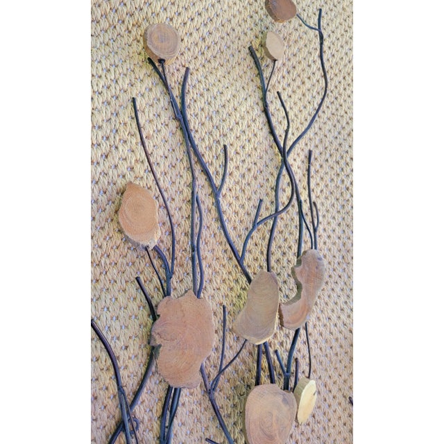 A pair of organic MCM style tall metal and natural wood wall sculptures. The wall art consists of black metal branches...