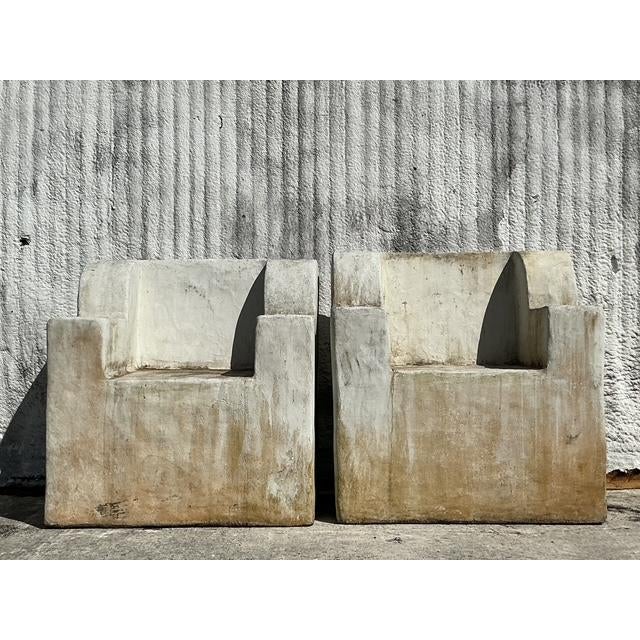 Make a bold statement with this stunning pair of monumental cast concrete over fiberglass chairs, blending sculptural...