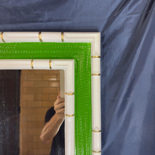 Step into the world of timeless elegance with this stunning vintage mid-century faux bamboo and grasscloth wall mirror....