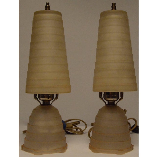 This is a nice pair of vintage Art Deco vanity lamps. They have soft gold frosted with stepped glass shades and matching...